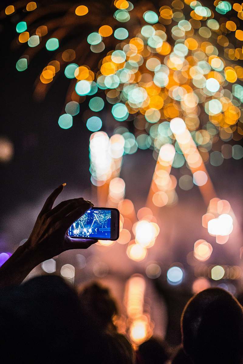 mobile phone person holding smartphone capturing fireworks geneva